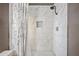 The walk in shower includes a modern rainfall shower head and marble tiling at 2929 E Broadway Rd # 50, Mesa, AZ 85204