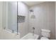 Modern bathroom with gray tiled walls, decorative shower niche, and glass shower door at 3325 S Shafer Dr, Tempe, AZ 85282