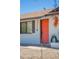 Close-up of a vibrant orange front door with modern accents and desert-friendly landscaping at 3325 S Shafer Dr, Tempe, AZ 85282
