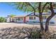 Charming single-story home featuring a white exterior, vibrant orange front door and desert landscaping at 3325 S Shafer Dr, Tempe, AZ 85282