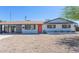 Inviting single-story home with a colorful front door, desert landscaping, and a convenient carport at 3325 S Shafer Dr, Tempe, AZ 85282