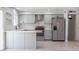 Contemporary kitchen with stainless steel appliances, light gray cabinets, and stylish range hood at 3325 S Shafer Dr, Tempe, AZ 85282