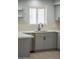 Bright kitchen featuring a stainless steel sink, faucet, quartz countertops, and gray cabinets at 3325 S Shafer Dr, Tempe, AZ 85282