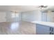 Open living area featuring sleek floors, a kitchen with bar seating, and ample natural light at 3325 S Shafer Dr, Tempe, AZ 85282