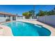 A view of an inviting pool surrounded by lush landscaping and a privacy fence at 3325 S Shafer Dr, Tempe, AZ 85282