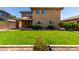 Beautiful backyard with manicured lawn, well-maintained landscaping, and a glimpse of a covered patio at 3338 E Coconino Dr, Gilbert, AZ 85298