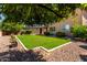 A lush green lawn and meticulously maintained landscaping create a serene backyard retreat at 3338 E Coconino Dr, Gilbert, AZ 85298