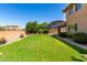 Beautiful backyard featuring green lawn, desert landscaping, and block wall fencing at 3338 E Coconino Dr, Gilbert, AZ 85298