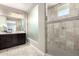 Bathroom featuring a walk-in shower, dark wood vanity, and a frosted glass partition at 3338 E Coconino Dr, Gilbert, AZ 85298