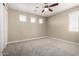Bright bedroom with neutral walls, carpet, and multiple windows offering natural light at 3338 E Coconino Dr, Gilbert, AZ 85298