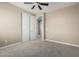 Cozy bedroom features neutral walls, carpet flooring, and closet with sliding doors at 3338 E Coconino Dr, Gilbert, AZ 85298