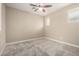 Clean and bright bedroom with cozy carpet, ceiling fan, and natural light at 3338 E Coconino Dr, Gilbert, AZ 85298