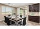 Dining area with a modern table set, view to backyard patio, and built-in cabinets at 3338 E Coconino Dr, Gilbert, AZ 85298