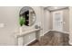 Elegant entryway featuring wood flooring, a console table, and a decorative round mirror at 3338 E Coconino Dr, Gilbert, AZ 85298