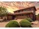 Inviting two-story home with a three-car garage, stone accents, and manicured landscaping at 3338 E Coconino Dr, Gilbert, AZ 85298