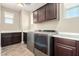 Well-lit laundry room features modern washer and dryer, stylish cabinetry, and durable tiled floors at 3338 E Coconino Dr, Gilbert, AZ 85298