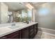 Main bathroom showcasing double sinks, a vanity, and walk-in shower at 3338 E Coconino Dr, Gilbert, AZ 85298