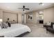 Comfortable main bedroom with carpet, ceiling fan, and ensuite bath at 3338 E Coconino Dr, Gilbert, AZ 85298