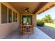 Inviting covered patio is equipped with a ceiling fan, a dining table, and chairs at 3338 E Coconino Dr, Gilbert, AZ 85298