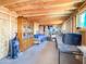 Unfinished basement space with exposed beams and plywood subflooring, offering ample storage at 3515 E Kings Ave, Phoenix, AZ 85032