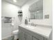 Bright bathroom featuring a granite countertop vanity, a toilet, and a mirrored medicine cabinet at 3515 E Kings Ave, Phoenix, AZ 85032