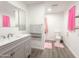 Bathroom featuring a vanity, a toilet with a pink shower curtain, and gray wood floors at 3515 E Kings Ave, Phoenix, AZ 85032