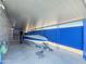 Carport with a boat on a trailer, blue fence and gravel, and a metal roof at 3515 E Kings Ave, Phoenix, AZ 85032