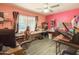 Pink office with hardwood floors, PC setup, large window, and multiple crafting items at 3515 E Kings Ave, Phoenix, AZ 85032