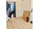 A brightly lit room with tile flooring and an open doorway at 4316 W Rose Ln, Glendale, AZ 85301