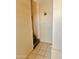 Hallway featuring tiled flooring, access to the stairs, and traditional wall decor at 4316 W Rose Ln, Glendale, AZ 85301