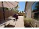 Paver patio with grill, table, and privacy wall is perfect for outdoor dining and entertaining at 4527 E Amberwood Dr, Phoenix, AZ 85048