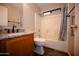 Bathroom featuring a single sink vanity, tile floors and shower-tub combination with shower curtain at 4527 E Amberwood Dr, Phoenix, AZ 85048