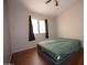 Bedroom featuring a large window with curtains and wood laminate floors at 4527 E Amberwood Dr, Phoenix, AZ 85048