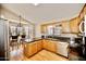 Bright kitchen featuring granite countertops, stainless steel appliances, and wood cabinets at 4527 E Amberwood Dr, Phoenix, AZ 85048
