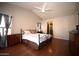 Main bedroom with wood floors, ceiling fan, and neutral color palette at 4527 E Amberwood Dr, Phoenix, AZ 85048