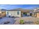Backyard with a covered patio, gravel landscaping, and beautiful blue skies at 5267 E Diatomite Dr, San Tan Valley, AZ 85143