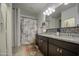 Stylish bathroom with double vanity, granite countertop, framed mirror, and decorative shower curtain at 5267 E Diatomite Dr, San Tan Valley, AZ 85143