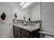 Bathroom showcasing a double vanity with granite countertop, stylish backsplash, and modern faucets and fixtures at 5267 E Diatomite Dr, San Tan Valley, AZ 85143