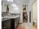 Bathroom showcasing double sinks, mosaic backsplash, and closet with a full view of interior at 5267 E Diatomite Dr, San Tan Valley, AZ 85143