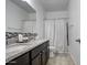 Bathroom featuring a double vanity with granite countertop and a combined shower-tub, offering functionality at 5267 E Diatomite Dr, San Tan Valley, AZ 85143