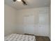 Minimalist bedroom with neutral walls, carpeted floors, and a double door closet with a ceiling fan at 5267 E Diatomite Dr, San Tan Valley, AZ 85143