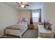 Bright bedroom featuring a ceiling fan, a comfortable bed, and a stylish window treatment at 5267 E Diatomite Dr, San Tan Valley, AZ 85143