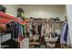 Walk-in closet with organized hanging clothes, shoe racks, and storage solutions maximizes space and convenience at 5267 E Diatomite Dr, San Tan Valley, AZ 85143