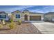 Charming single-story home featuring a well-manicured desert landscape and a two-car garage at 5267 E Diatomite Dr, San Tan Valley, AZ 85143