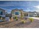 Inviting single-story home with desert landscaping, complemented by an attached two-car garage and blue skies at 5267 E Diatomite Dr, San Tan Valley, AZ 85143