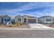 Charming single-story home featuring a low-maintenance desert-landscaped front yard and a two-car garage at 5267 E Diatomite Dr, San Tan Valley, AZ 85143
