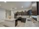 Stylish kitchen with granite countertops, dark cabinets, stainless steel appliances, and decorative backsplash at 5267 E Diatomite Dr, San Tan Valley, AZ 85143
