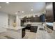 Well-lit kitchen features granite countertops, a kitchen island and stainless steel appliances at 5267 E Diatomite Dr, San Tan Valley, AZ 85143