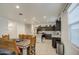 Open-concept kitchen and dining area featuring dark cabinets, stainless steel appliances, and a spacious island at 5267 E Diatomite Dr, San Tan Valley, AZ 85143
