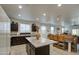 Modern kitchen featuring granite countertops, island with dark cabinets, and stainless steel appliances at 5267 E Diatomite Dr, San Tan Valley, AZ 85143